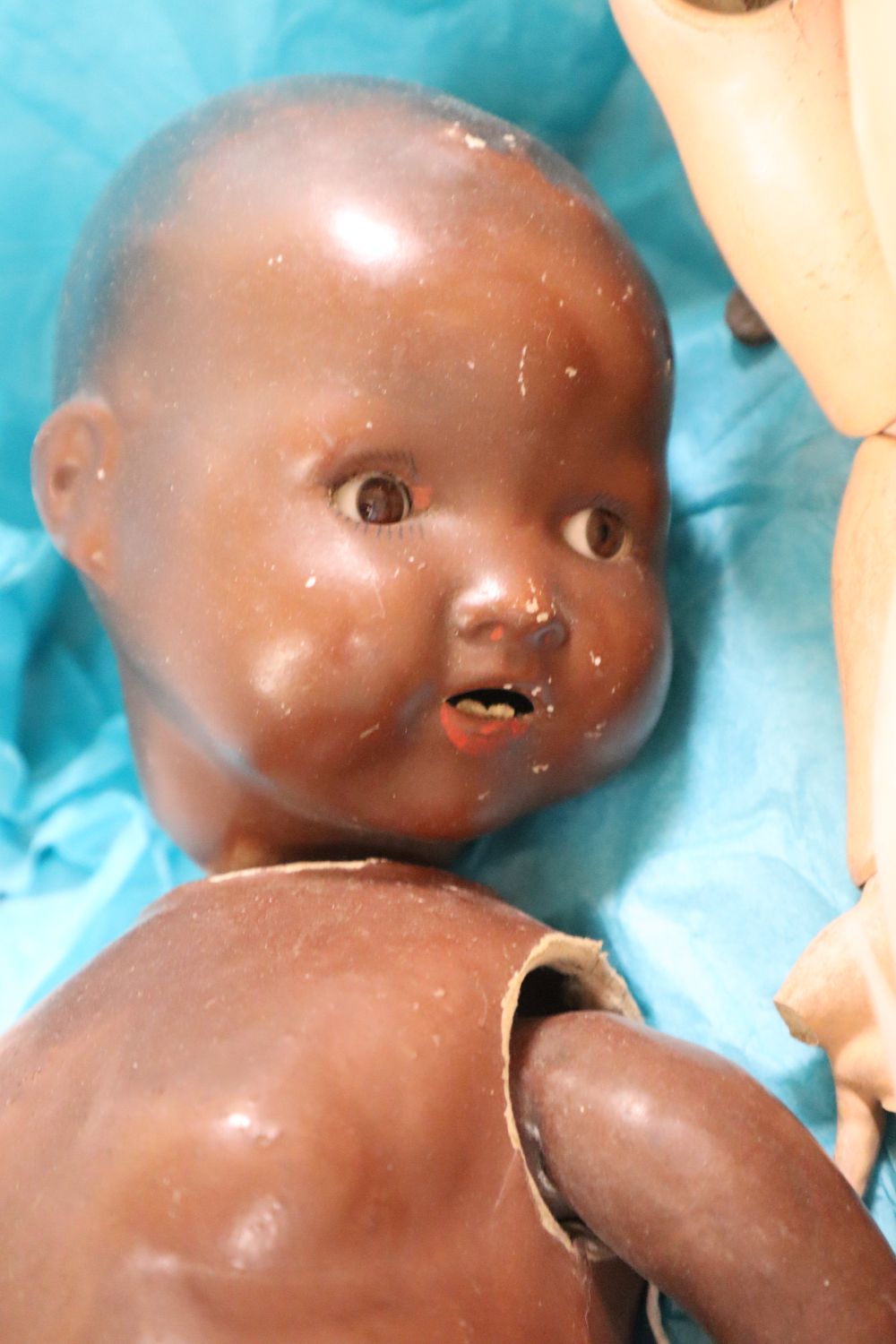 A Simon & Halbig bisque head jointed composition girl doll, H 22in and a jointed composition black doll (very a.f.)